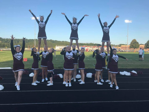 The cheerleaders doing 3 elevators with 3 cheerleaders in the front spiriting